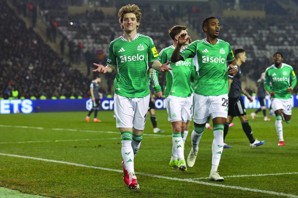 Newcastle United's English midfielder #10 Anthony Gordon celebrates a goal with teammates during the UEFA Champions League knockout phase play-off first leg football match between Qarabag and Newcastle at the Tofiq Bahramov Republican Stadium in Baku on February 18, 2026. (Photo by Giorgi ARJEVANIDZE / AFP)

