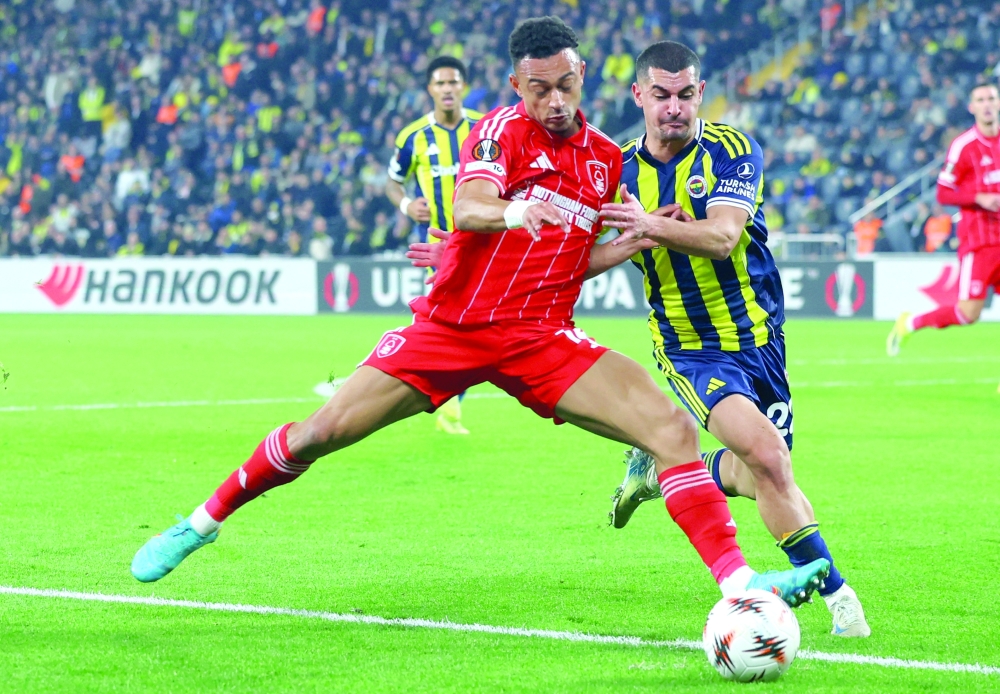 Soccer Football - UEFA Europa League - Play Off - First Leg - Fenerbahce v Nottingham Forest - Sukru Saracoglu Stadium, Istanbul, Turkey - February 19, 2026 Nottingham Forest's Omari Hutchinson in action with Fenerbahce's Munir Mercan REUTERS/Murad Sezer