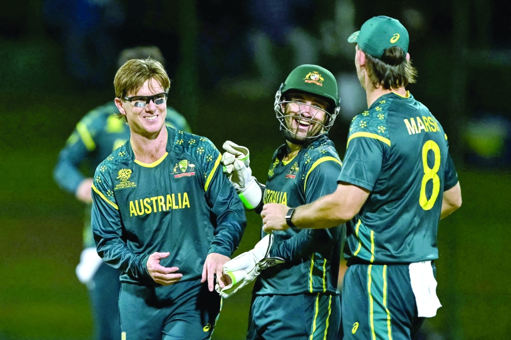 Australia's Adam Zampa (L) celebrates with teammates after taking the wicket of Oman's Shakeel Ahmed during the 2026 ICC Men's T20 Cricket World Cup group stage match between Oman and Australia at Pallekele International Cricket Stadium in Kandy on February 20, 2026.  (Photo by Ishara S. KODIKARA / AFP)
