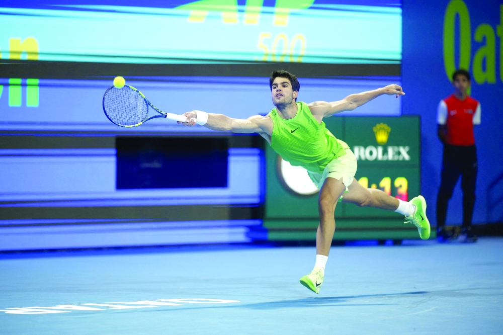 TOPSHOT - Spain's Carlos Alcaraz hits a return against Russia's Karen Khachanov during their men's singles quarterfinal match at the Qatar Open tennis tournament in Doha on February 19, 2026. (Photo by Karim JAAFAR / AFP)
