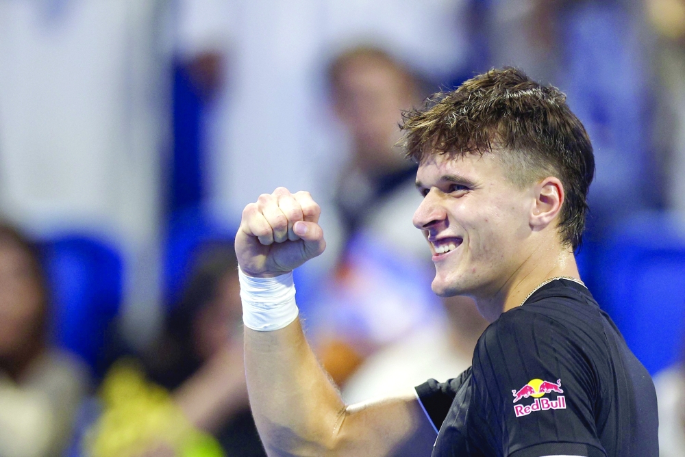 Czech Republic's Jakub Mensik reacts after winning the men痴 singles quarterfinal match against Italy's Jannik Sinner at the Qatar Open tennis tournament in Doha on February 19, 2026. (Photo by Karim JAAFAR / AFP)
