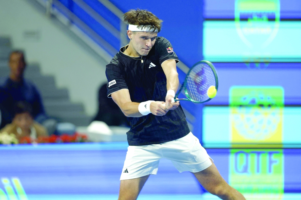 Czech Republic's Jakub Mensik hits a return against Italy's Jannik Sinner during their men's singles quarterfinal match at the Qatar Open tennis tournament in Doha on February 19, 2026. (Photo by Karim JAAFAR / AFP)
