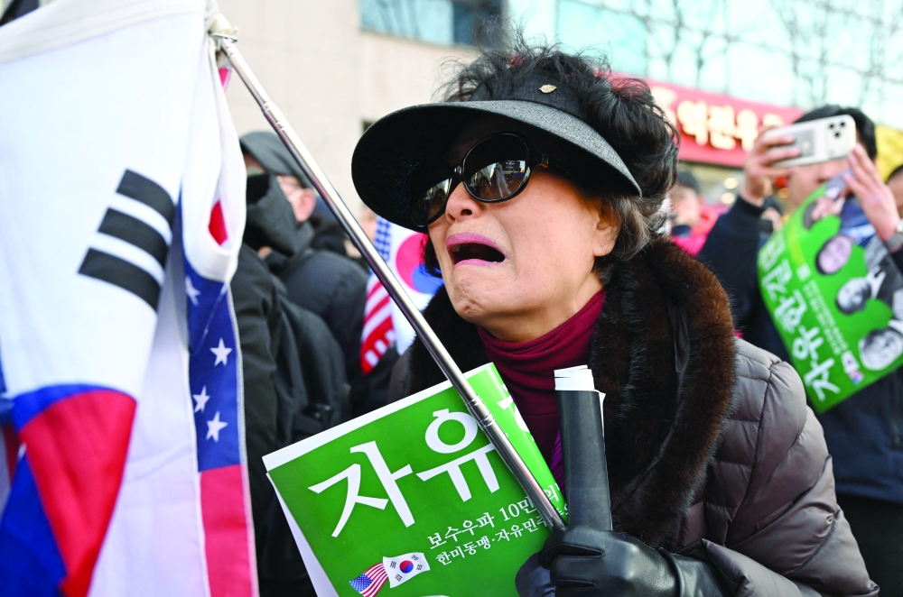Supporters of South Korea's impeached former president Yoon Suk Yeol react as they watch a live stream of Yoon's trial on his insurrection charges near the Seoul Central District Court. — AFP