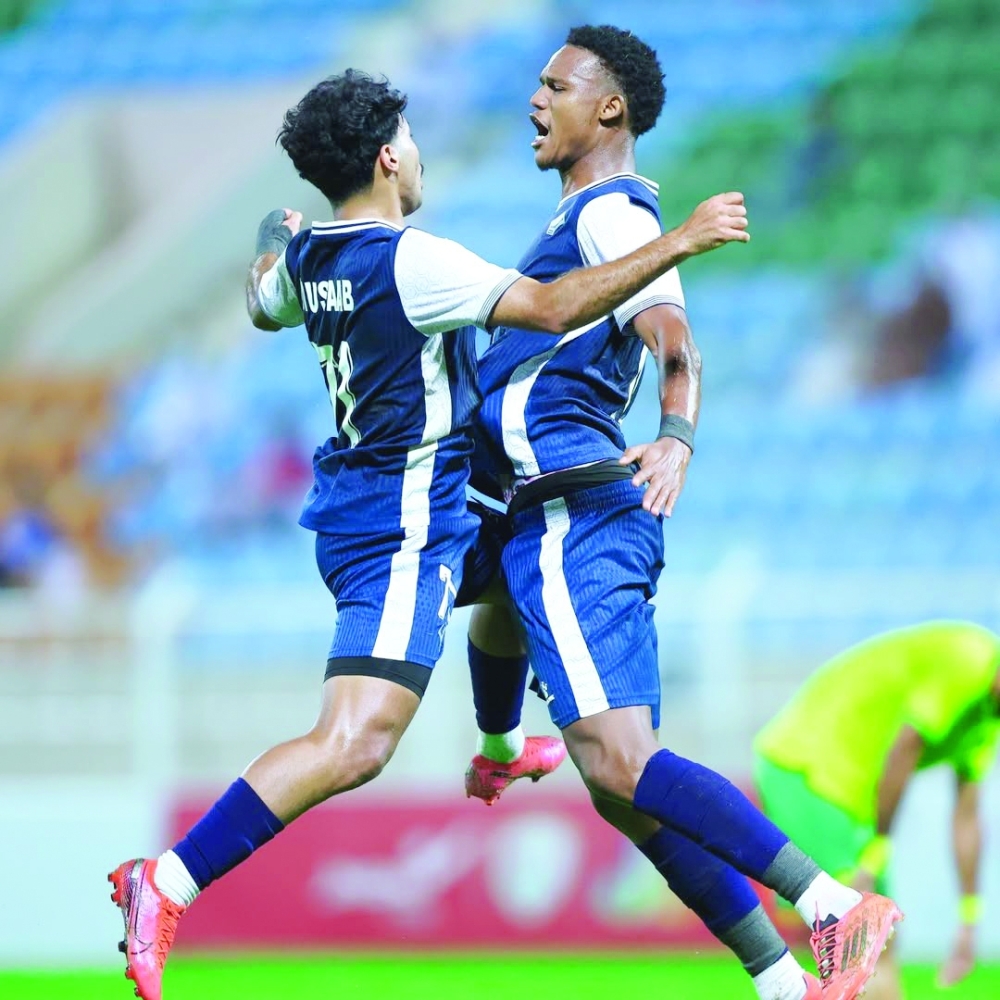 Al Shabab players celebrate scoring the winning goal.