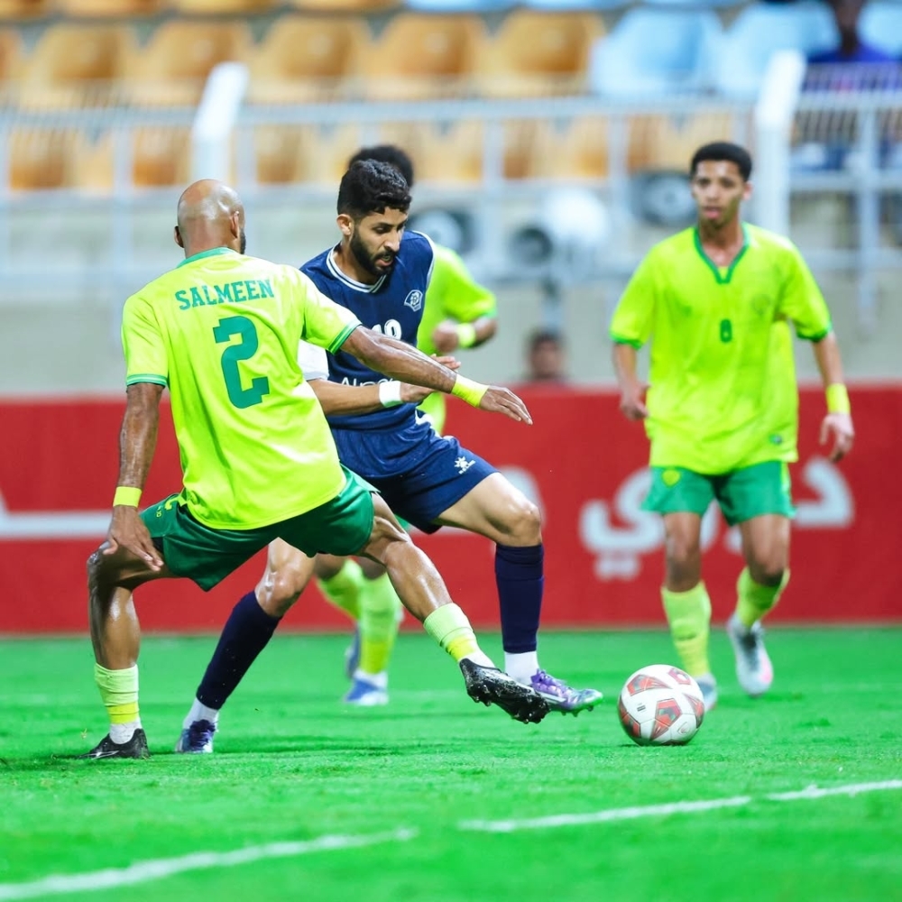 Al Shabab and Al Khabourah players fight for the ball.