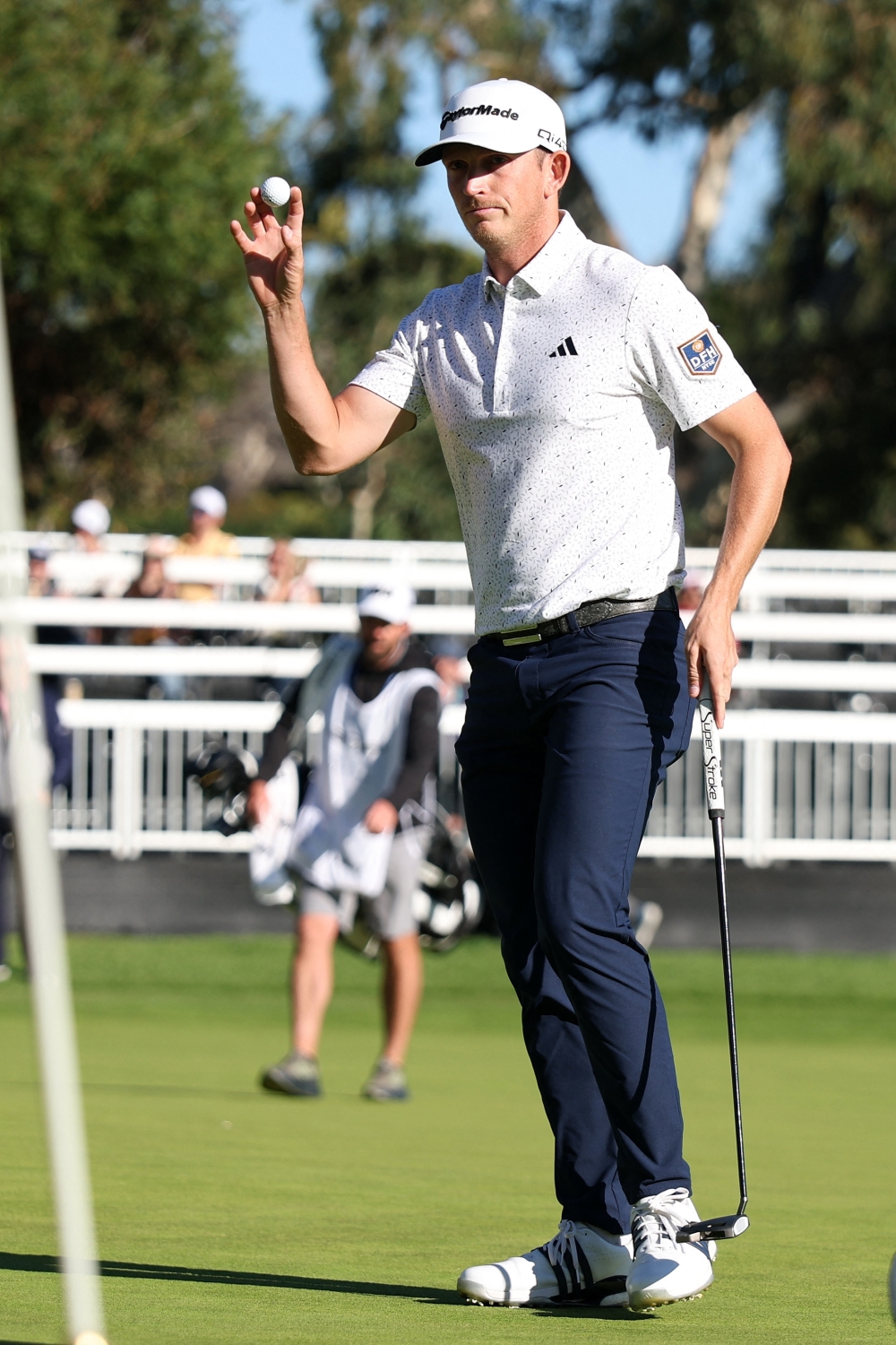 Jacob Bridgeman acknowledges the crowd after making a birdie putt on the 17th green 
