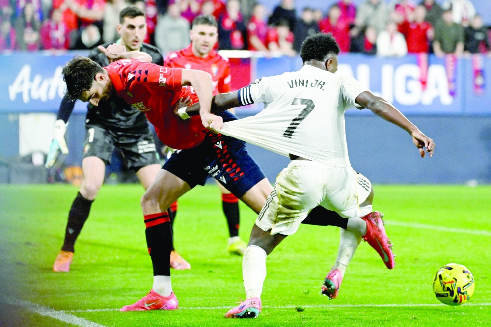 Alejandro Catena and Real Madrid's Brazilian forward Vinicius Junior fight for the ball during the Spanish league football match. — AFP