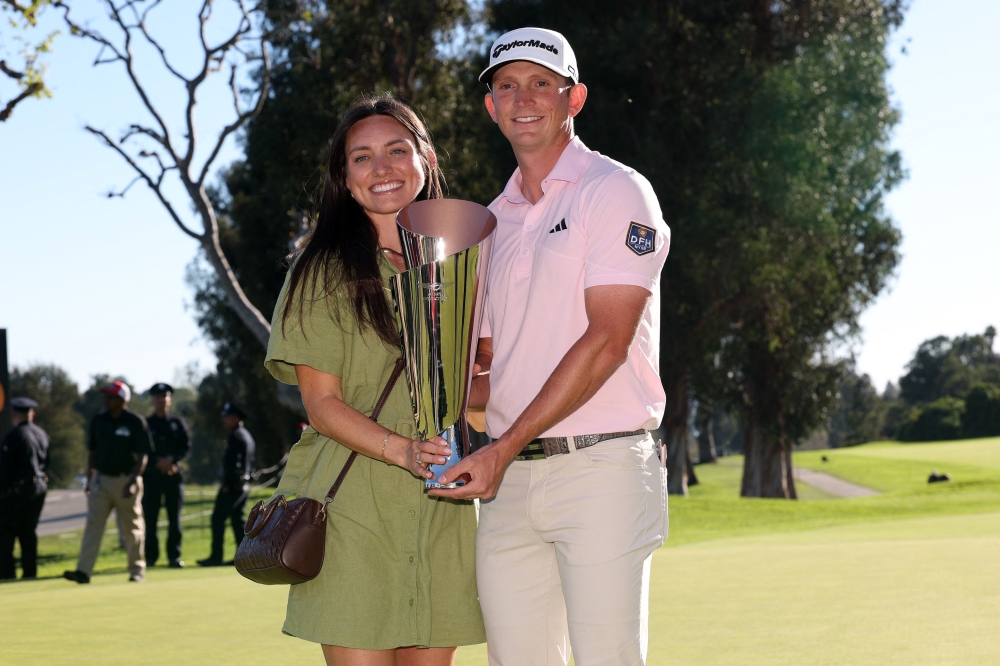  Jacob Bridgeman (right) and his wife Haley celebrate with the trophy   
