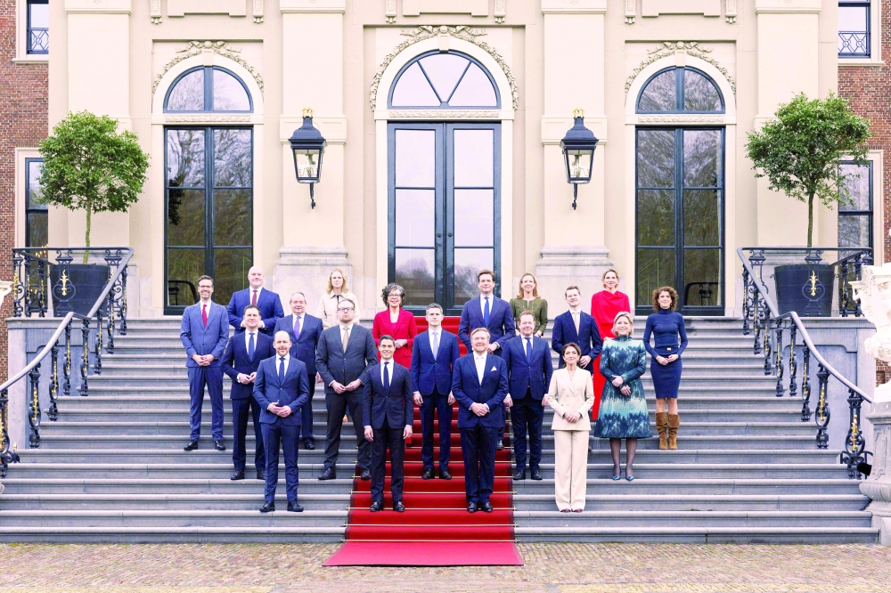 Netherlands' Willem-Alexander (C-R) next to new PM Rob Jetten (C-L) poses with members of the Jetten cabinet, at Huis ten Bosch Palace in The Hague. — AFP