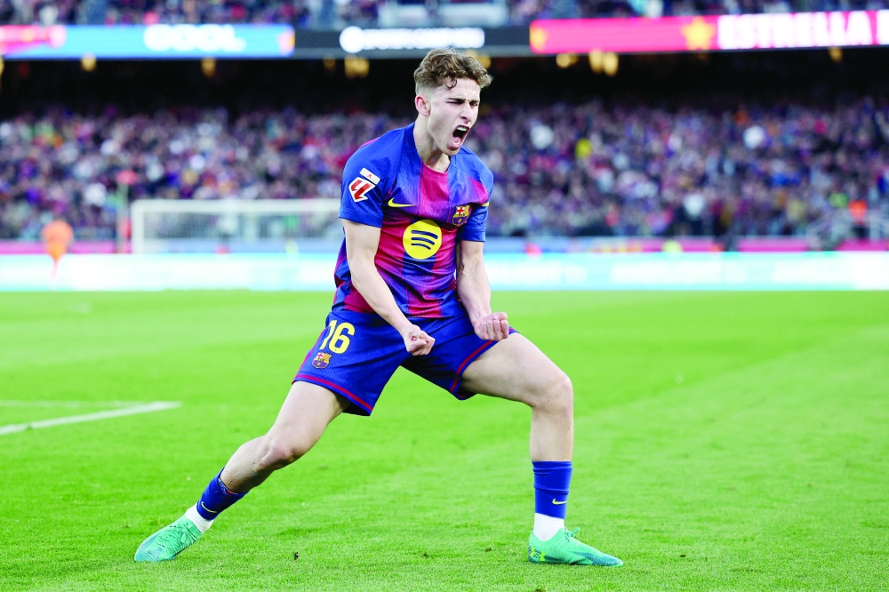 TOPSHOT - Barcelona's Spanish midfielder #16 Fermin Lopez celebrates scoring his team's third goal during the Spanish league football match between FC Barcelona and Levante UD at Camp Nou Stadium in Barcelona on February 22, 2026. (Photo by Josep LAGO / AFP)

