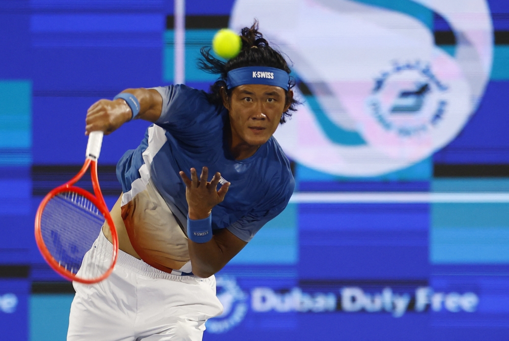  China's Zhizhen Zhang in action against Canada's Felix Auger-Aliassime  