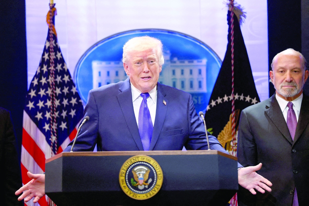 US President Donald Trump, flanked by Secretary of Commerce Howard Lutnick speaks during a press briefing at the White House. — Reuters