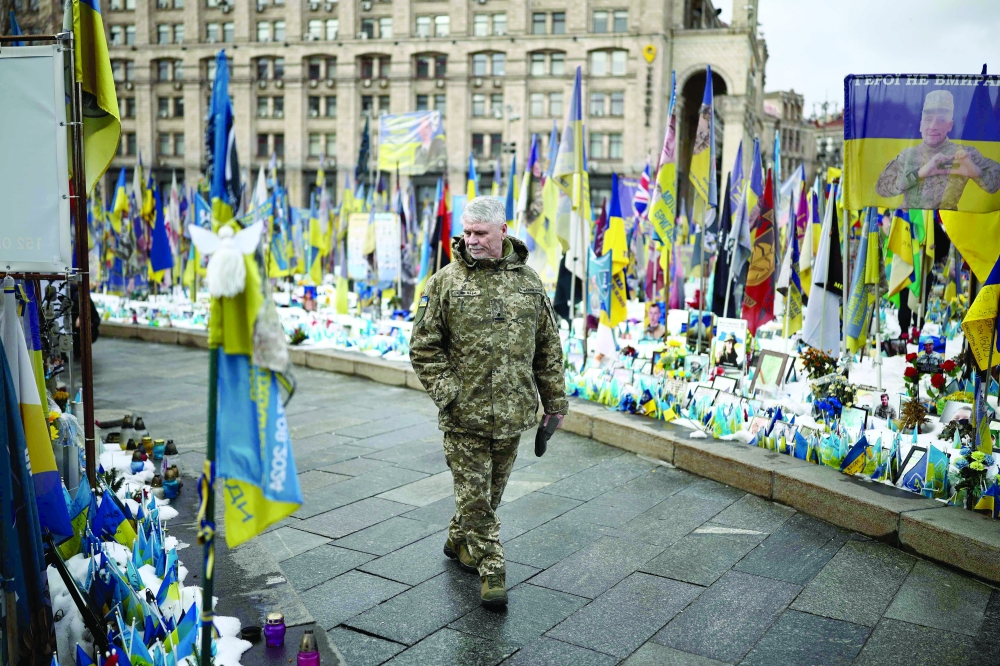 A man visits a makeshift memorial for Ukrainian and foreign soldiers, in Kyiv. — AFP