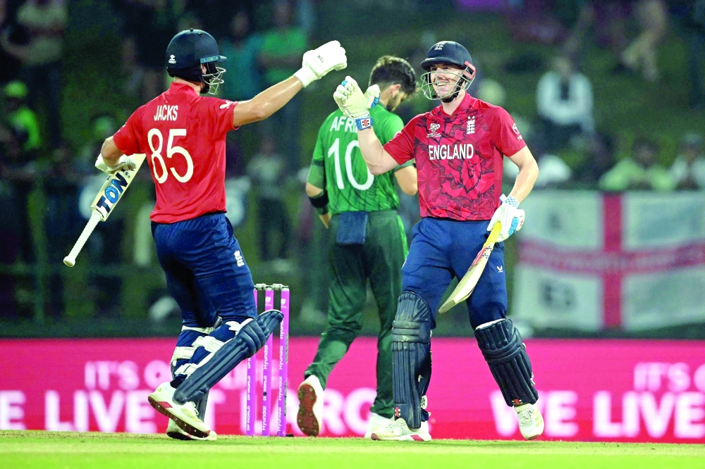 England captain Harry Brook (R) celebrates with teammate Will Jacks (L) after scoring his century (100 runs) during the 2026 ICC Men's T20 Cricket World Cup Super Eights match between England and Pakistan at the Pallekele International Cricket Stadium in Kandy on February 24, 2026.  (Photo by Dibyangshu SARKAR / AFP)
