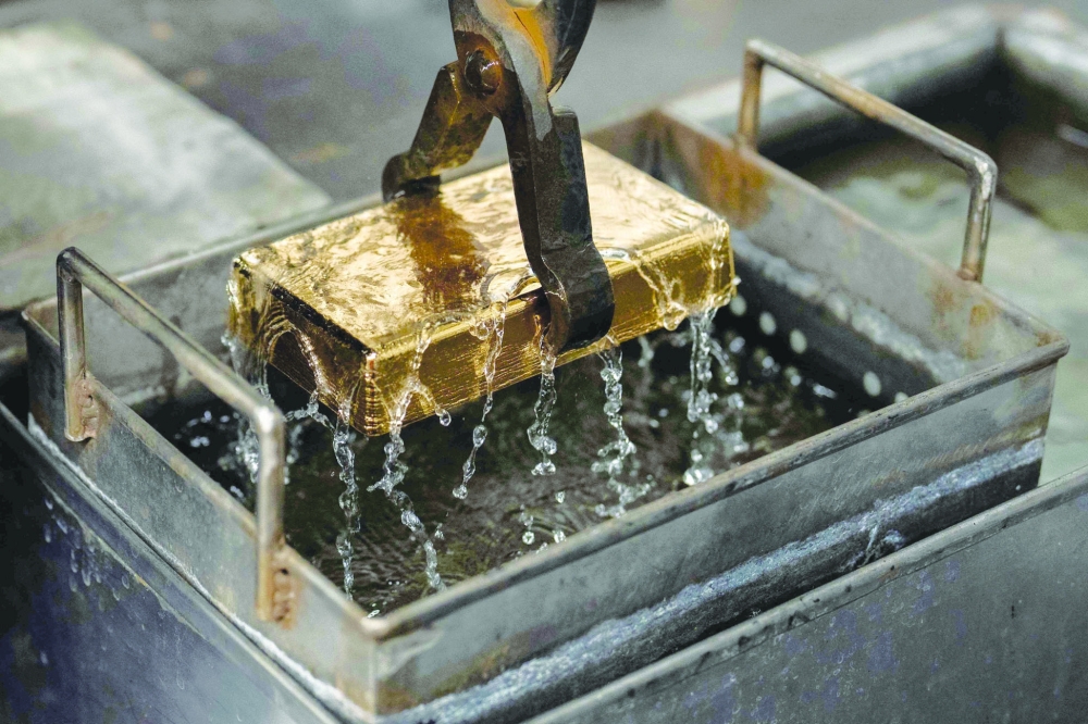 A gold bar is cooled in water after being molded at the Austrian Gold and Silver Refinery (Oegussa) in Vienna, Austria, on February 3, 2026. European and Asian stock markets struggled for direction February 4, 2026 following a tech-fuelled sell-off on Wall Street, while precious metals recovered further. - Austria OUT (Photo by GEORG HOCHMUTH / APA / AFP)