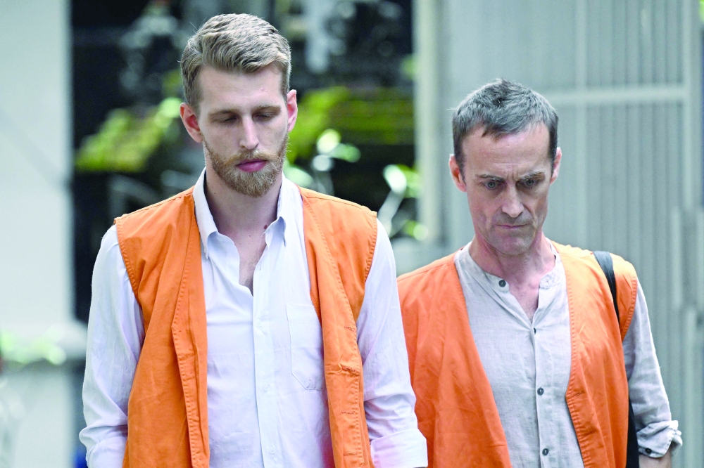 British nationals Kial Garth Robinson and Piran Ezra Wilkinson (R) during their trial in Denpasar on the Indonesian resort island of Bali. — AFP