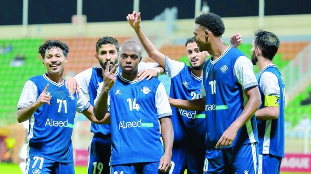 Al Shabab’s Kenean Markina celebrates with teammates after scoring a goal.