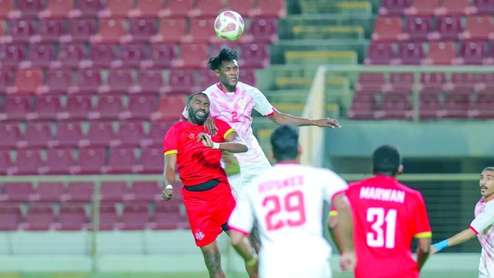 Oman Club and Dhofar players fight for the ball in the Jindal League.