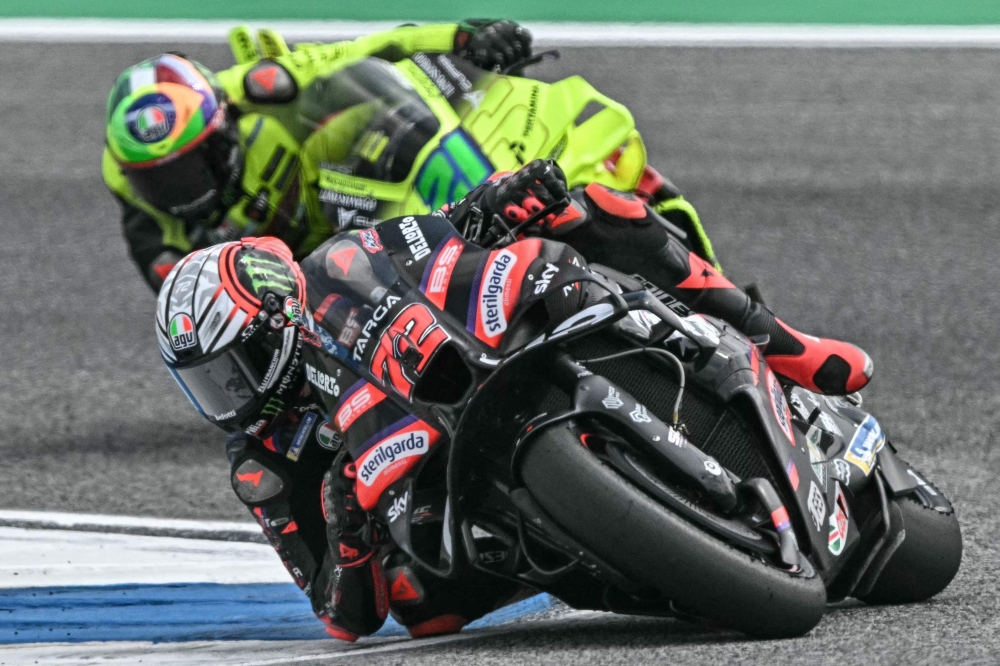 Aprilia Racing's Italian rider Marco Bezzecchi (front) and Pertamina Enduro VR64 Racing's Italian rider Franco Morbidelli ride