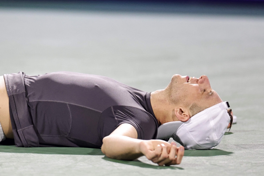 Netherlands' Tallon Griekspoor lies on the floor as he reacts after the winning 