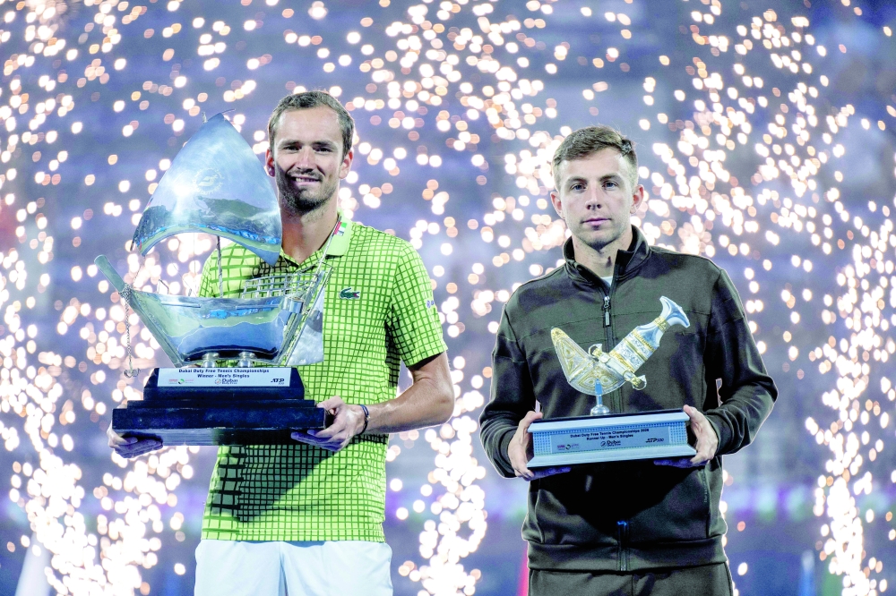 Russia's Daniil Medvedev (L) and Runner-up Netherlands' Tallon Griekspoor poses pose with their trophies after the men's singles final match at the Dubai Duty Free Tennis tournament in Dubai on February 28, 2026.  (Photo by Ryan Lim / AFP)
