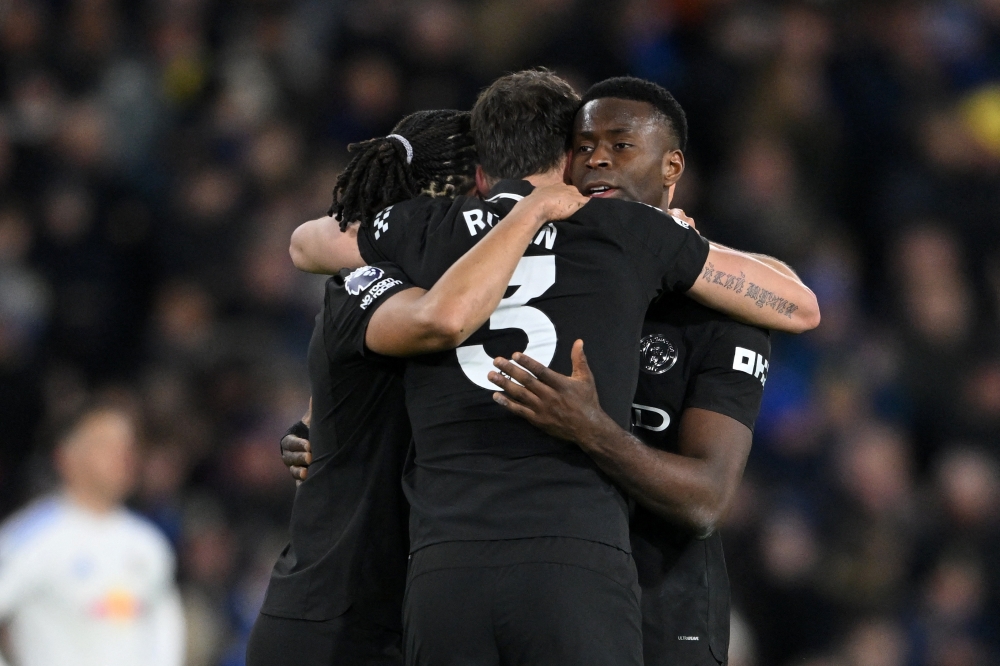   Manchester City's Marc Guehi celebrates after the match with Ruben Dias and Nathan Ake  
