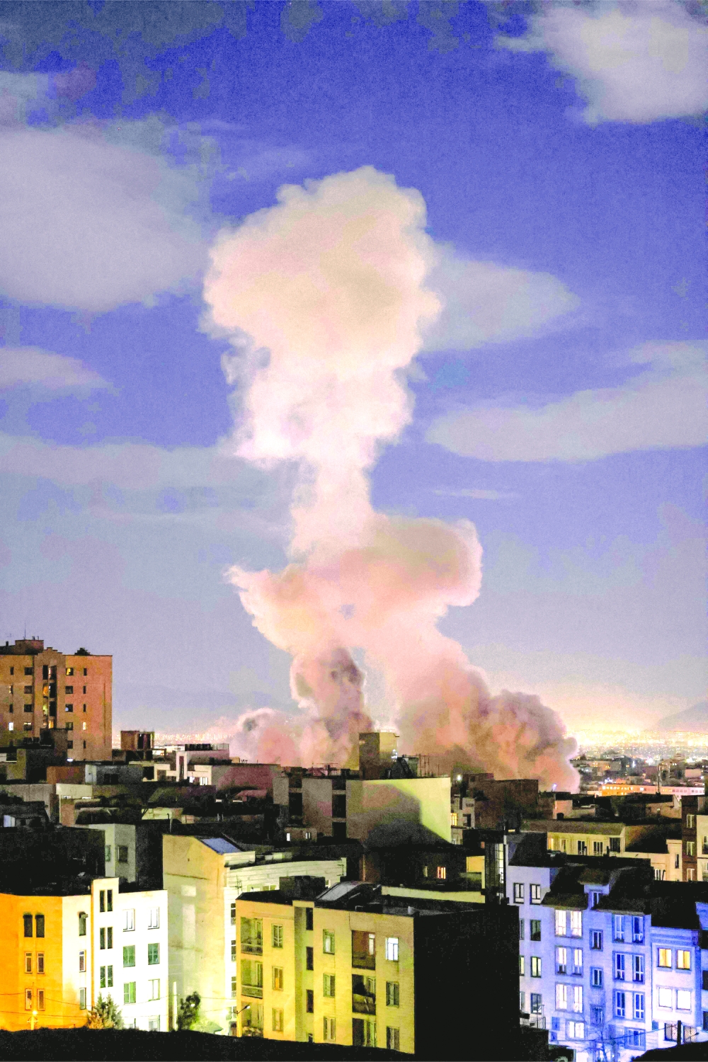 A smoke plume rises following a missile strike on a building in Tehran on Sunday. - AFP
