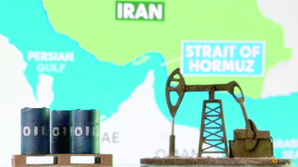 3D-printed oil barrels, an oil pump jack and a map showing the Strait of Hormuz and Iran appear in this illustration. — Reuters