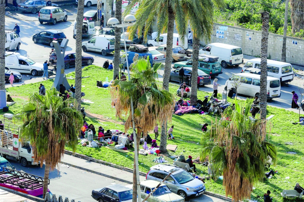Displaced families from southern Lebanon seek refuge in the garden of a public square. — AFP