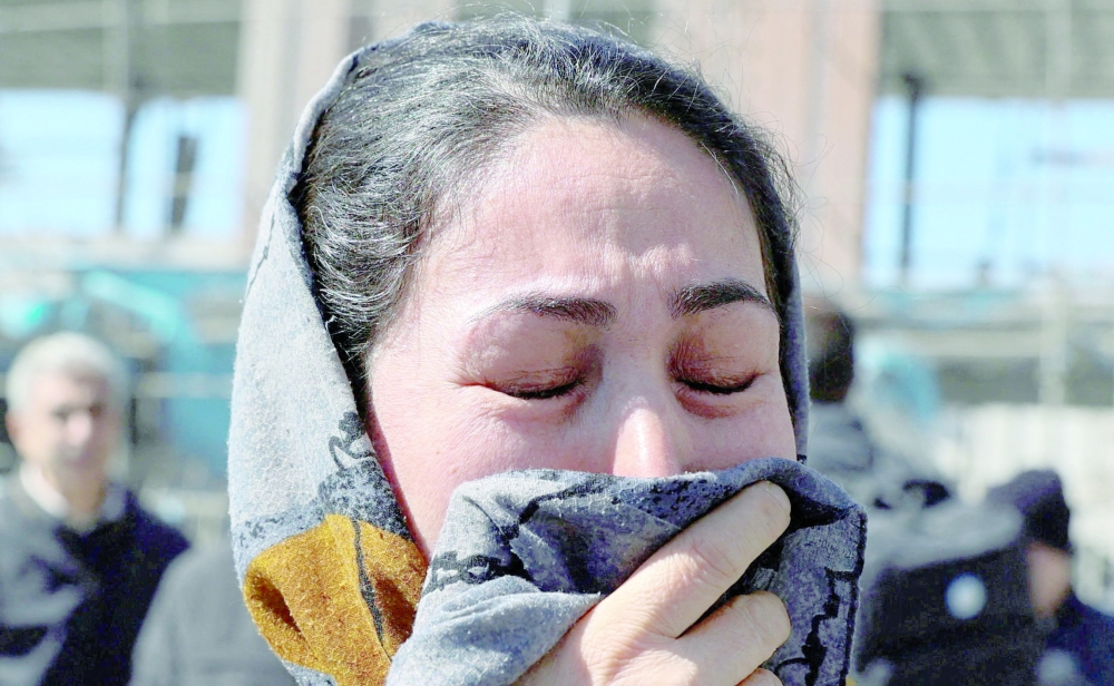 A womxan reacts following an Israeli and US strike on a police station in Tehran, Iran, on Tuesday. - Reuters