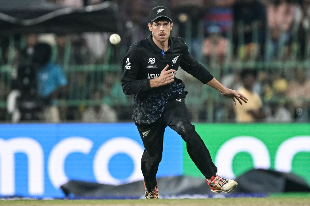 New Zealand's captain Mitchell Santner runs to field the ball during Super Eights match  