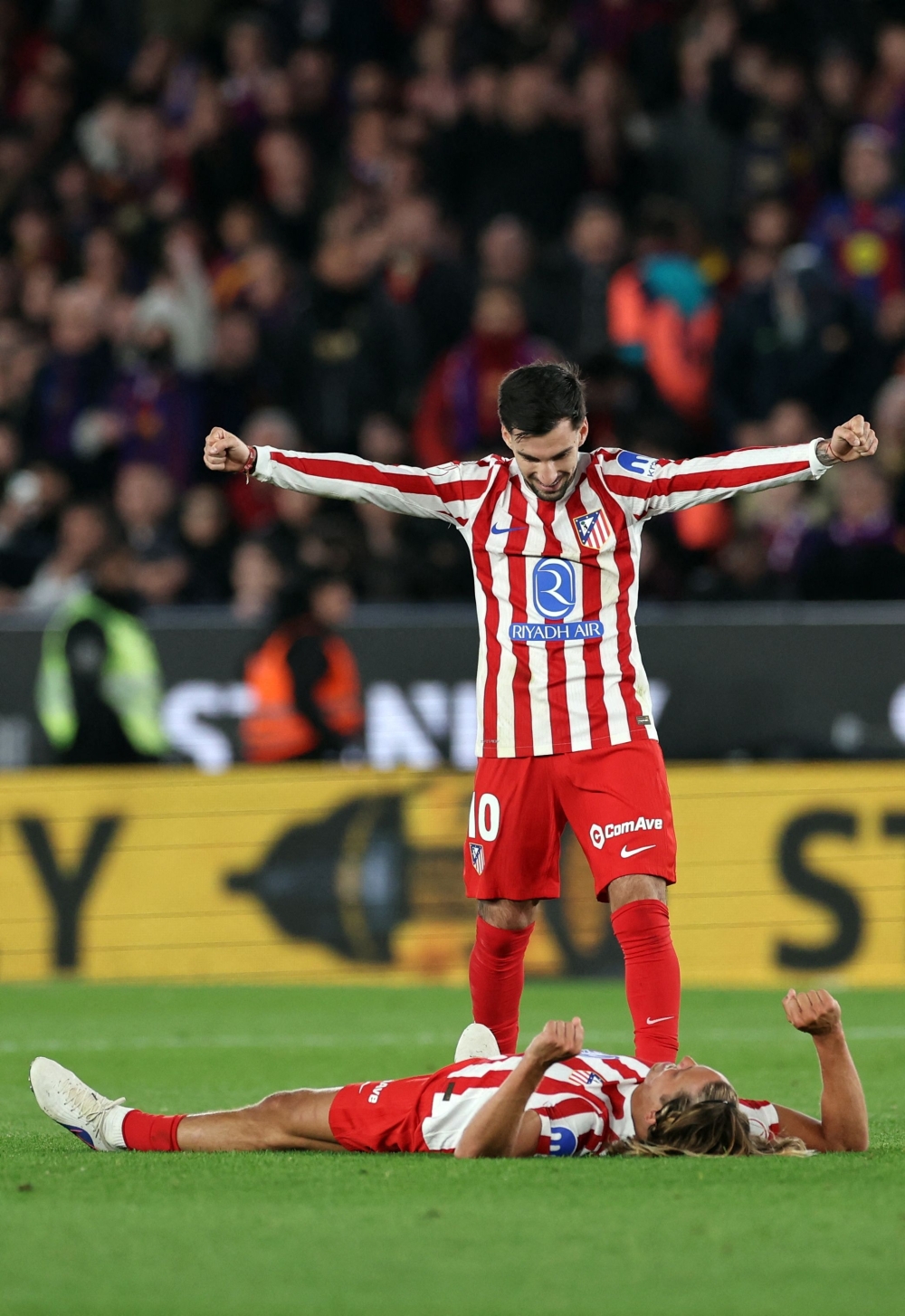 Atletico Madrid's Spanish forward #10 Alex Baena and  #14 Marcos Llorente (BOTTOM) celebrate their victory  
