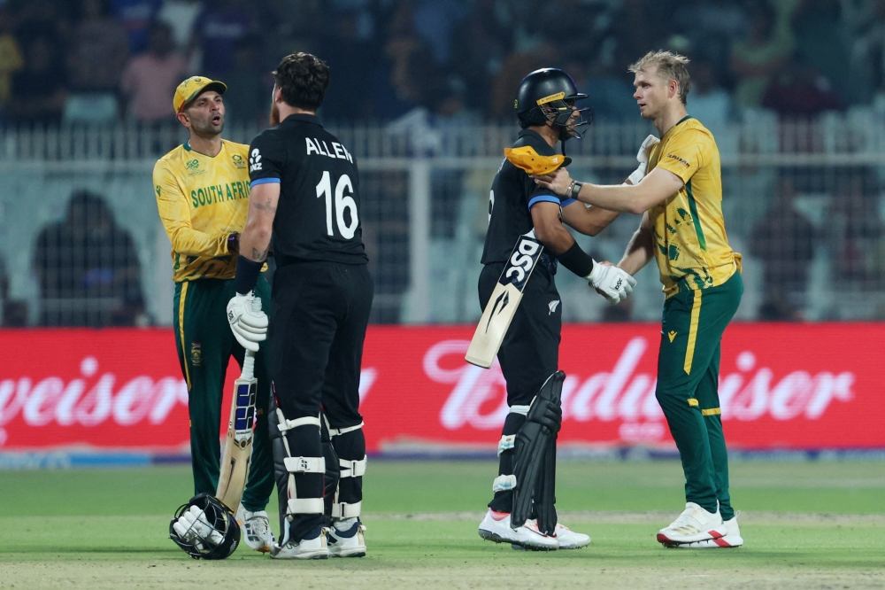   New Zealand's Finn Allen and Rachin Ravindra with South Africa's Corbin Bosch after the match  