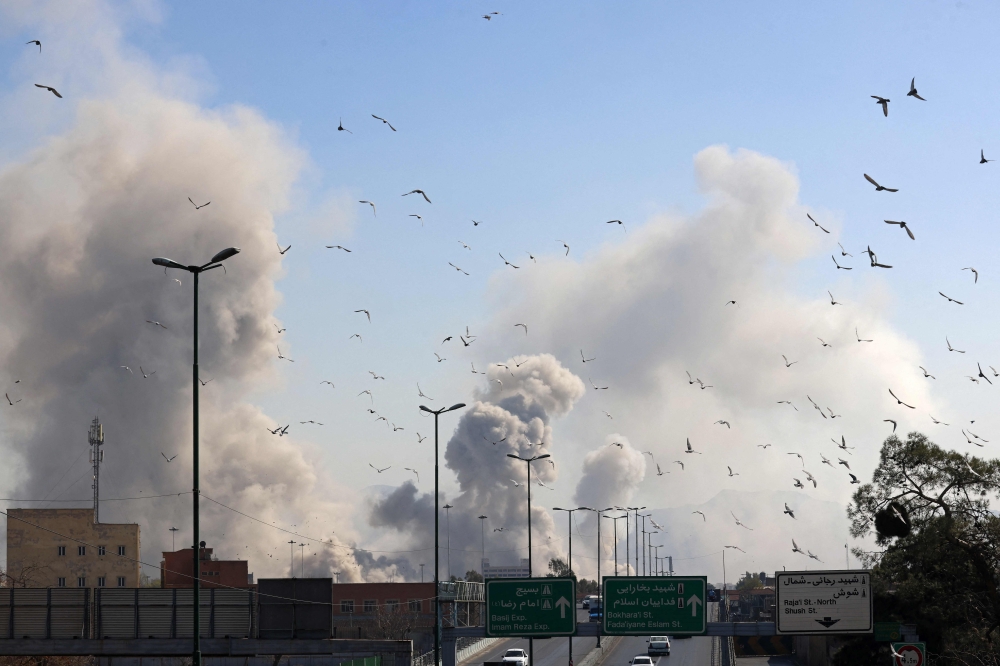 A plume of smoke rises after a strike on the Iranian capital of Tehran on March 5, 2026