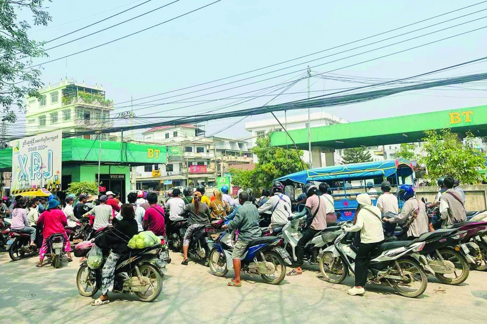 Motorists queue at a petrol station in Tachileik, Myanmar. - AFP