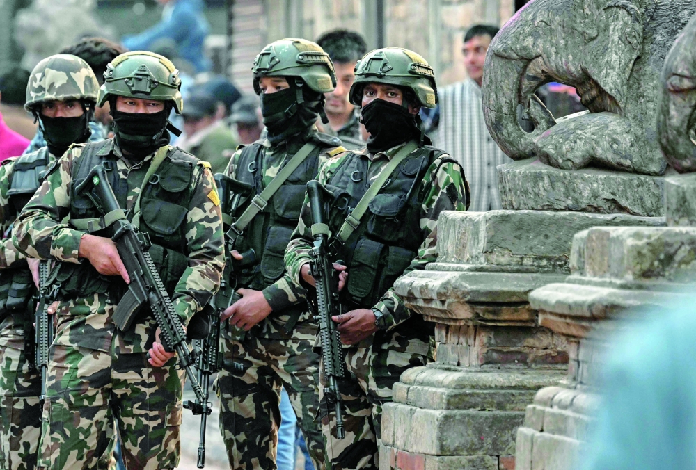 Security personnel stand guard at the Patan Durbar Square during Nepal's general election in Lalitpur. - AFP