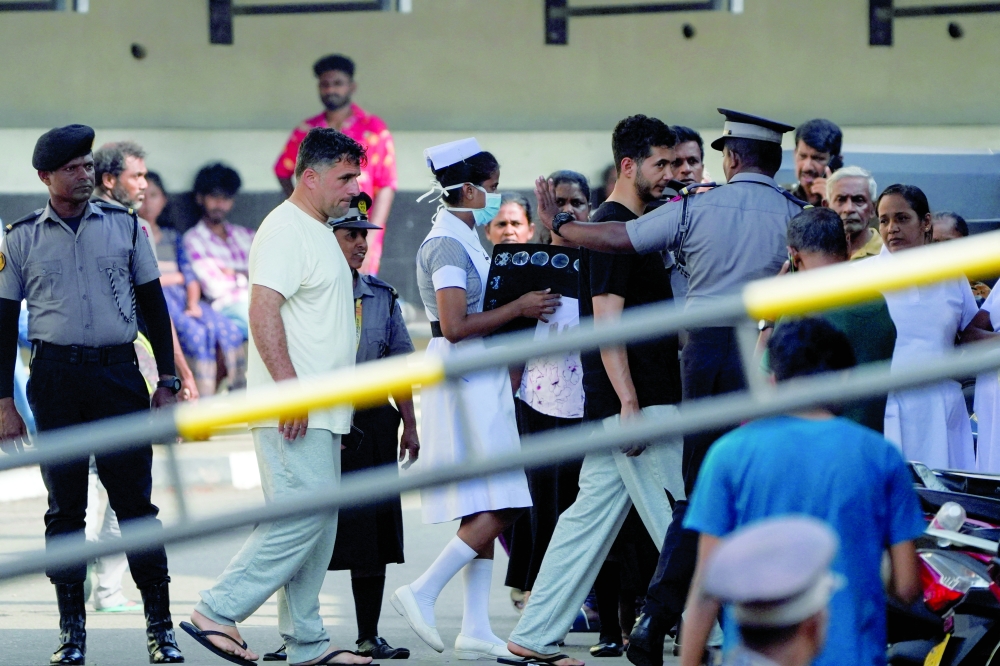 Injured Iranian sailors walk on Galle National Hospital premises to change ward, where they are receiving treatment, following a submarine attack on the Iranian military ship, IRIS Dena, off the coast of Sri Lanka in Galle. — Reuters