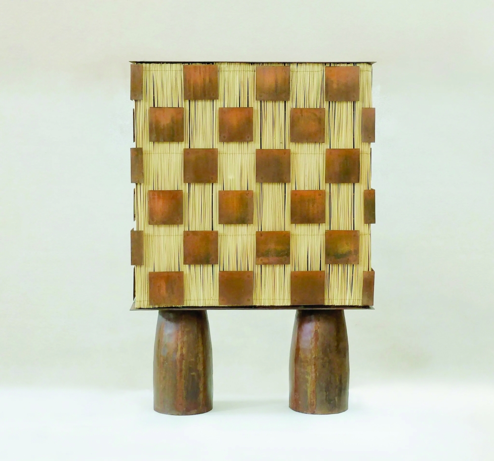 The Ganymede cabinet by Altin is made of sea rush and metal.