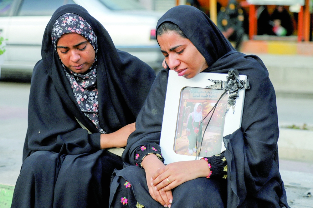 People mourn on the day of the funeral of the victims following a reported strike on a school in Minab, Iran. — AFP File