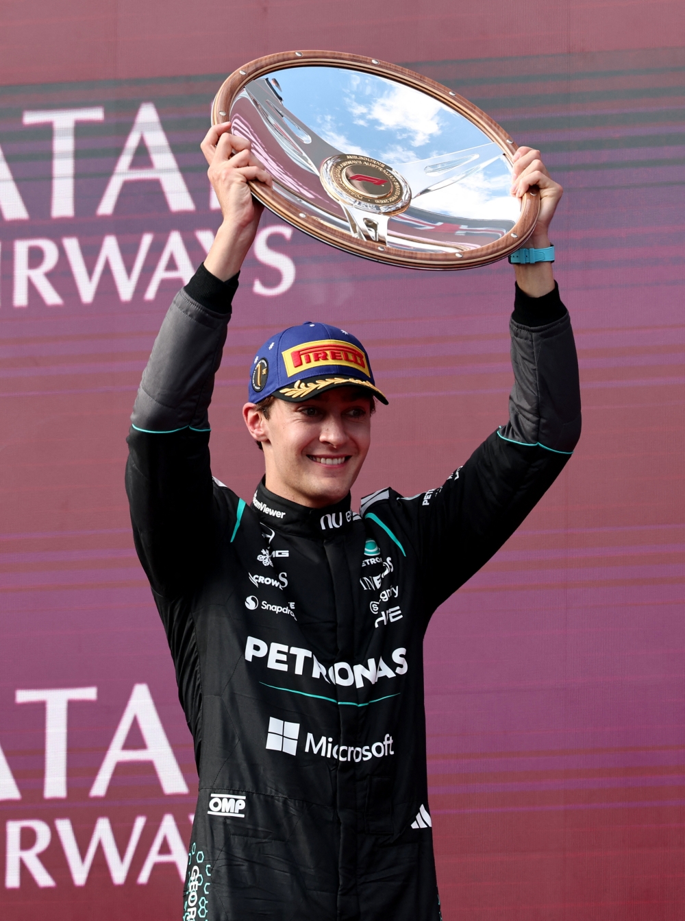  Mercedes' George Russell celebrates with the trophy