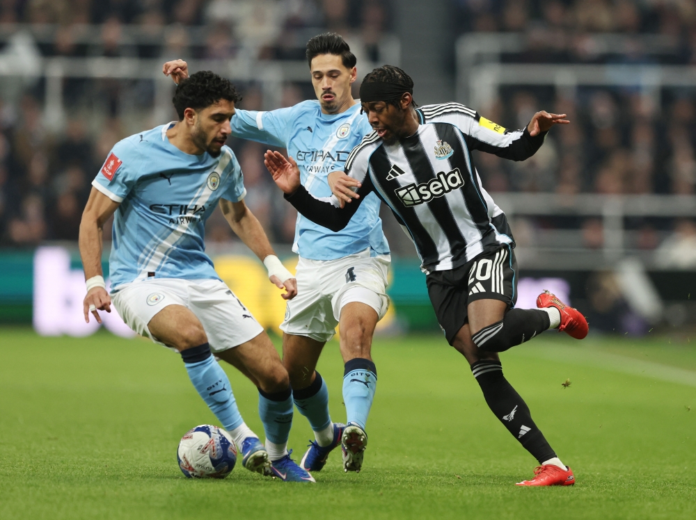   Manchester City's Omar Marmoush and Manchester City's Tijjani Reijnders in action with Newcastle United's Anthony Elanga 