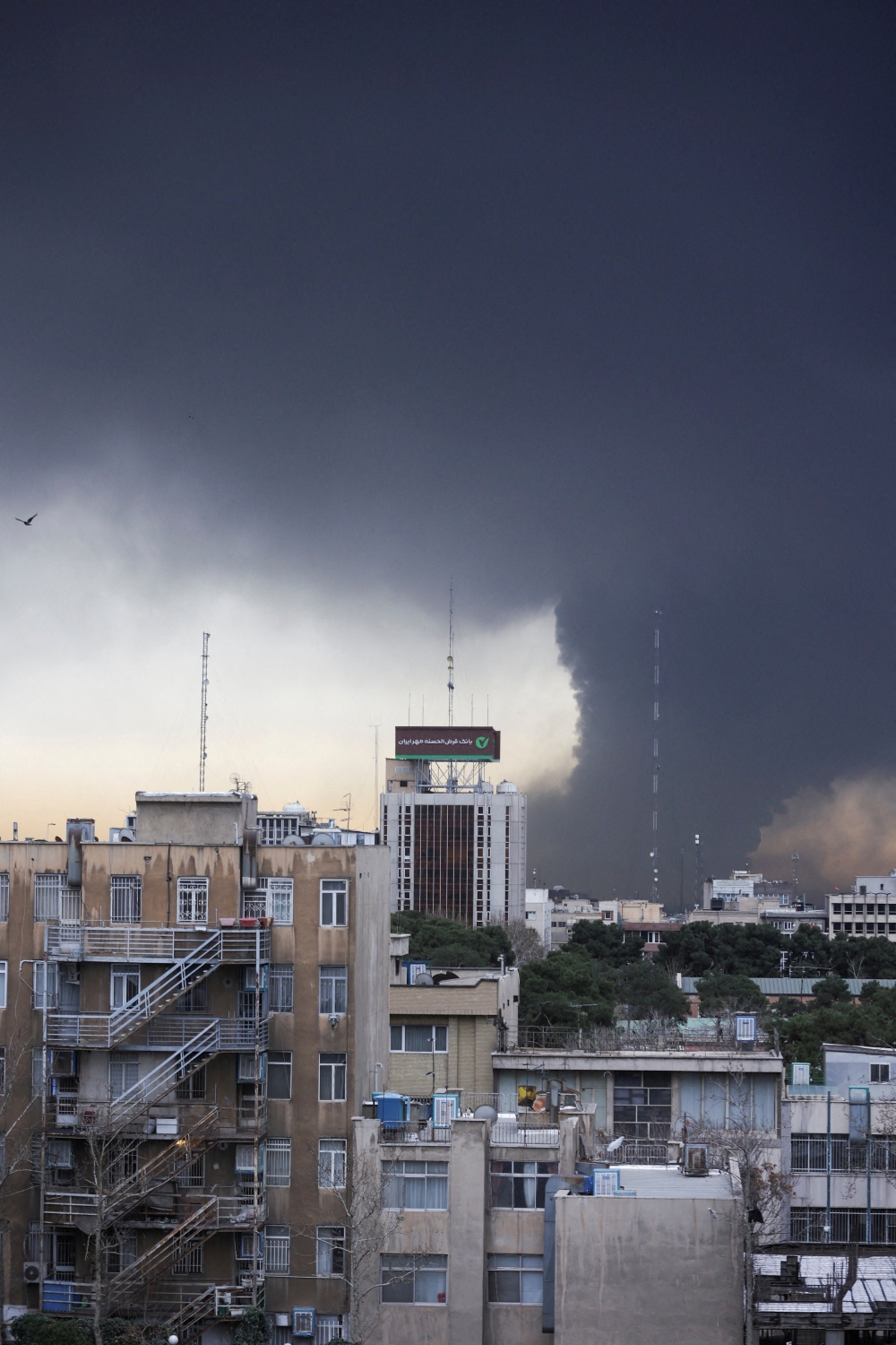 Smoke rises after a reported strike on fuel tanks at an oil refinery, amid the U.S.-Israeli conflict with Iran, in Tehran