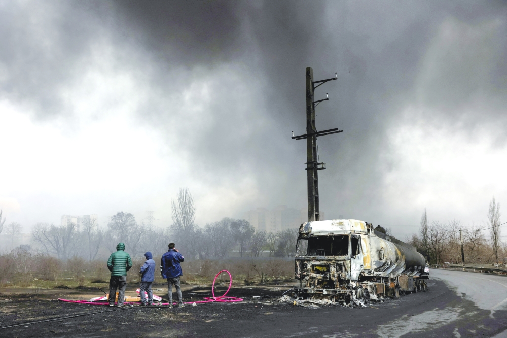 Smoke rises after a reported strike on Shahran fuel tanks, in Tehran. — Reuters