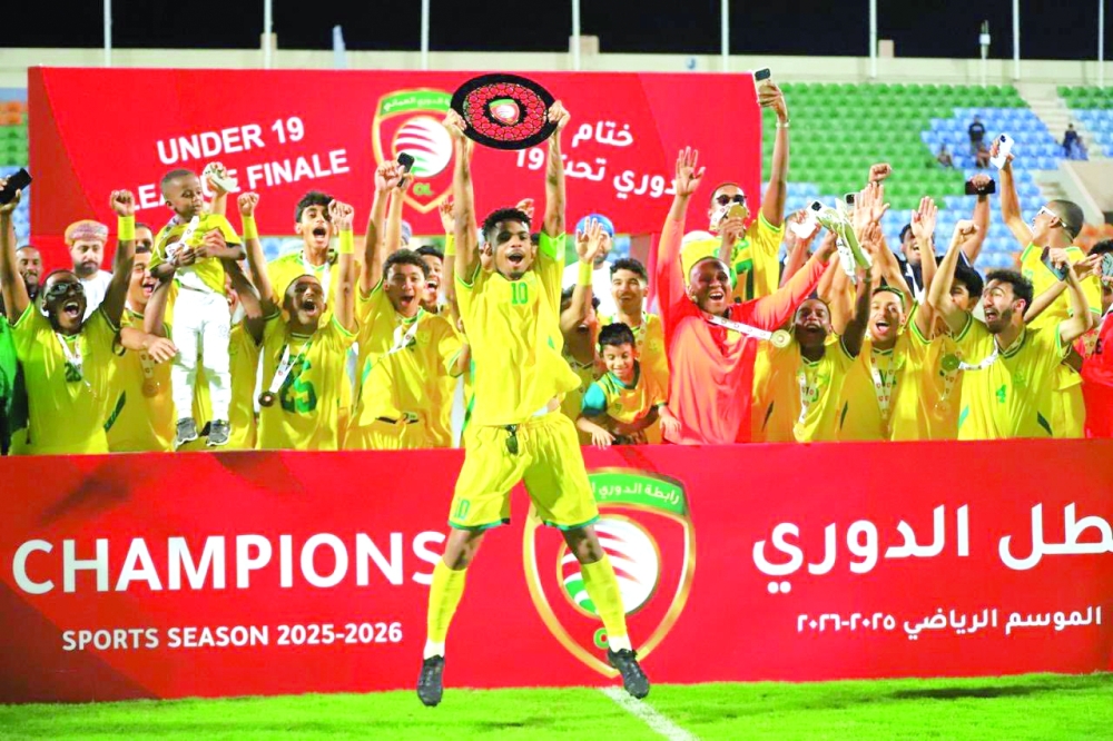 Seeb players celebrate their U19 Football League title on the podium
