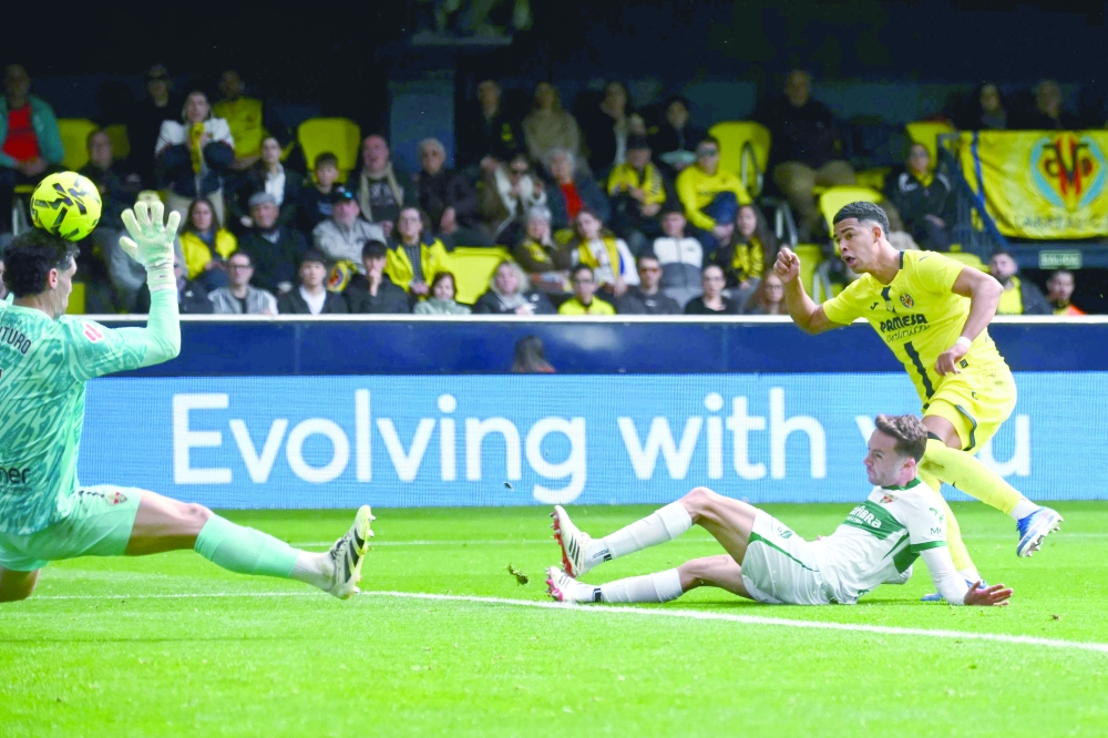 Villarreal's Uruguayan defender #15 Santiago Mourino scores his team's second goal during the Spanish league football match between Villarreal CF and Elche CF at La Ceramica Stadium in Vila-real on March 8, 2026. (Photo by JOSE JORDAN / AFP)
