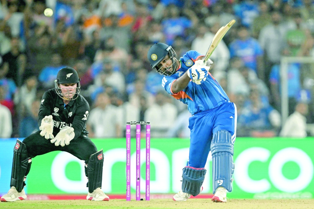 TOPSHOT - India's Sanju Samson (R) plays a shot as New Zealand's wicketkeeper Tim Seifert fields during the 2026 ICC Men's T20 Cricket World Cup final match between India and New Zealand at the Narendra Modi Stadium in Ahmedabad on March 8, 2026.  (Photo by Dibyangshu SARKAR / AFP)
