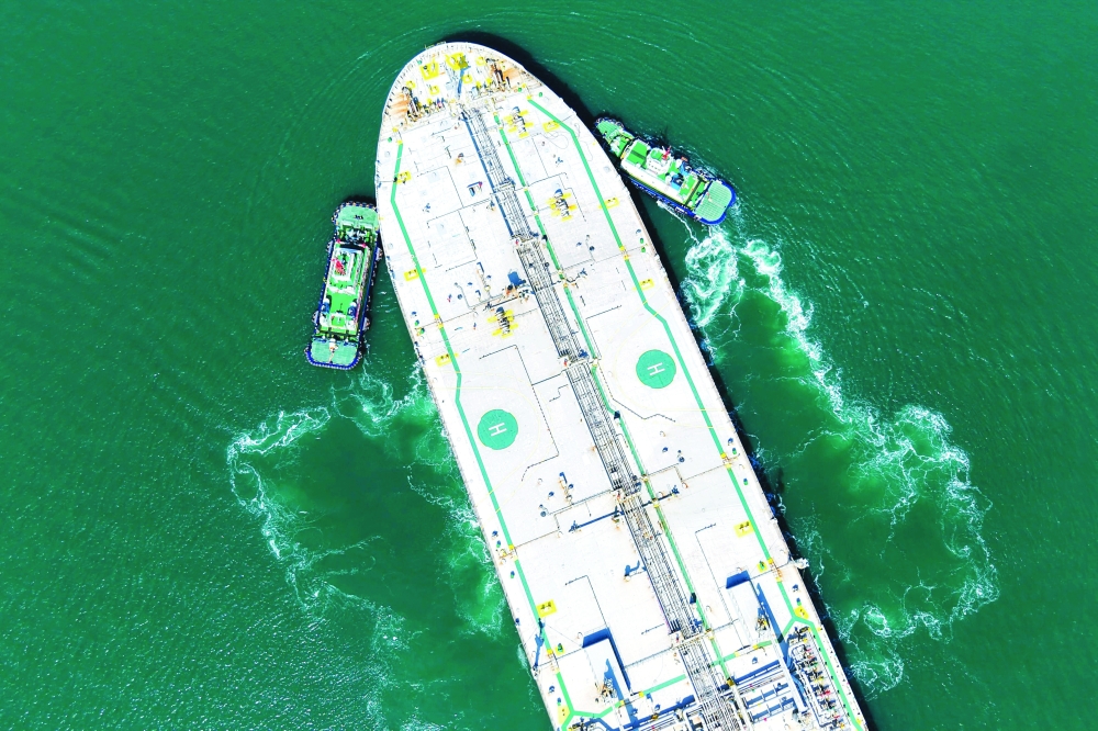 A crude oil tanker is guided to a berth at the oil terminal at the port in Qingdao, in China's eastern Shandong province. — AFP