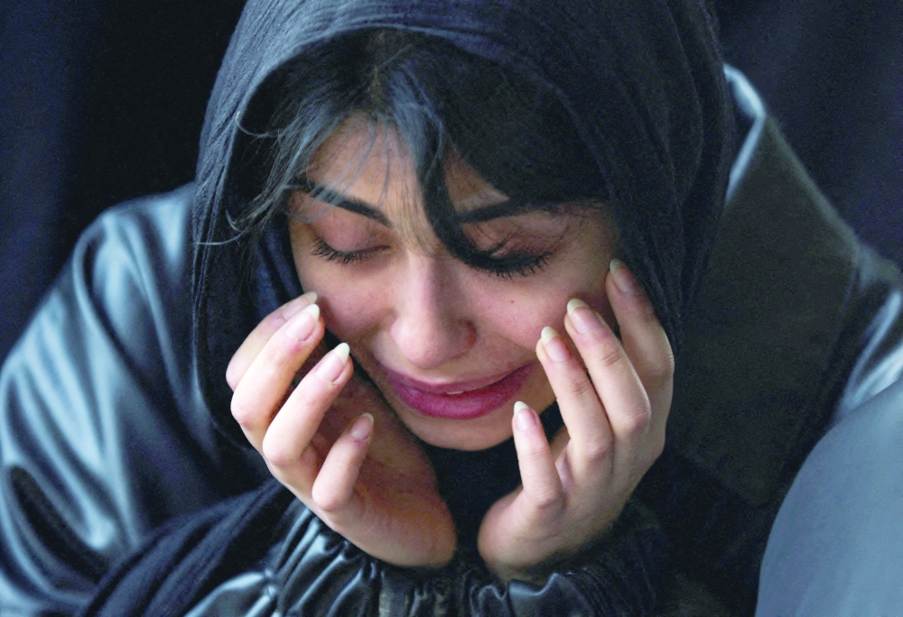 A mourner reacts as she attends a funeral ceremony for victims of Israeli and US strikes in Tehran, Iran, on Monday. - Reuters