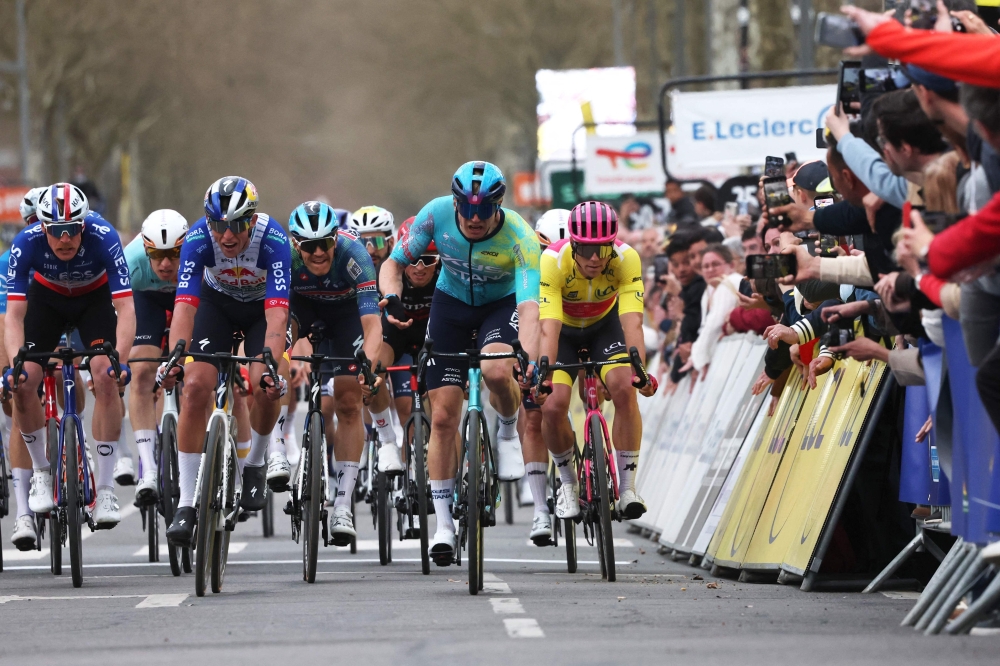 XDS Astana Team's German rider Max Kanter (2nd R) celebrates as he crosses the finish line 