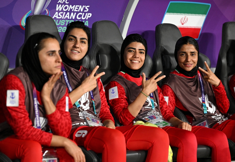 Iran players Zahra Ghanbari, Mona Hamoudi and Atefeh Ramezanizadeh react from the bench Dave Hunt/AAP
